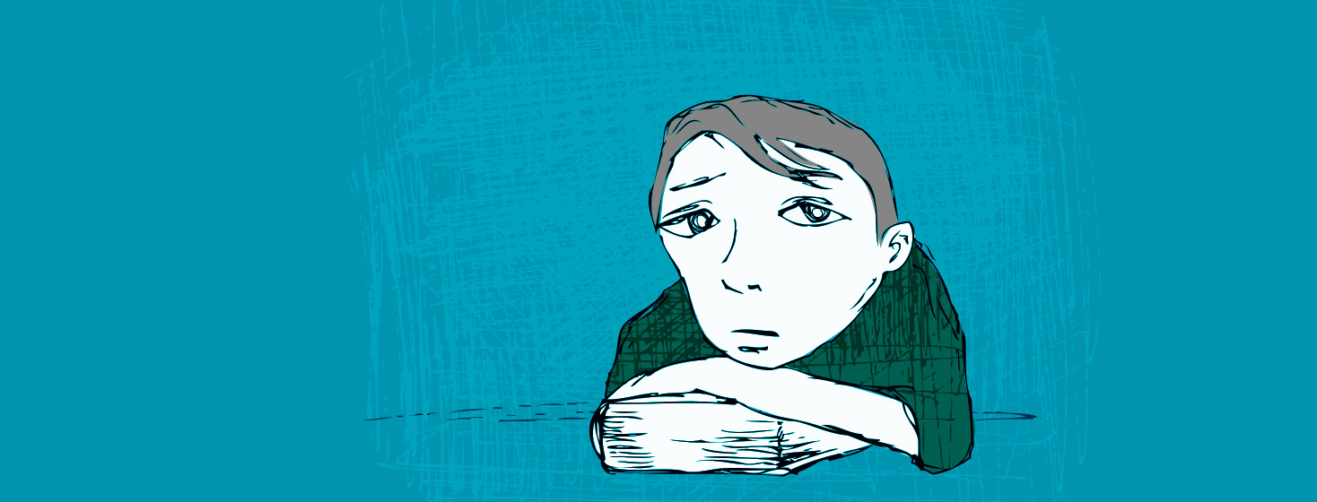 A person resting with their chin on their hands looking sad.