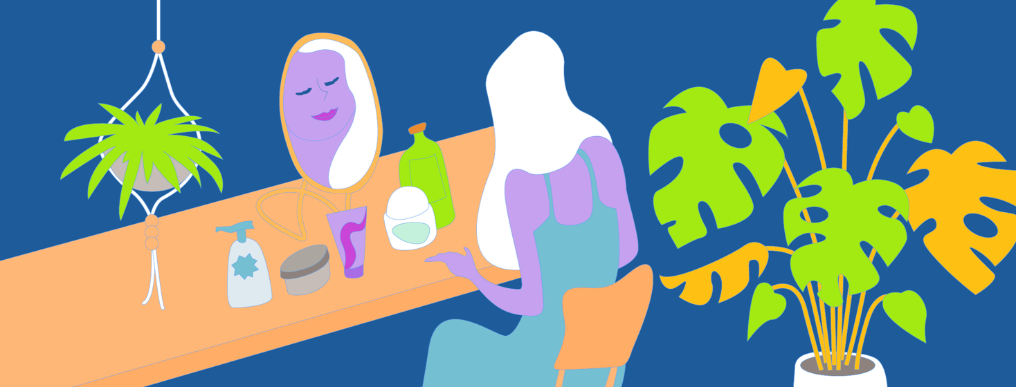 A woman gets ready for her day by sitting in front of a magnifying mirror with makeup.