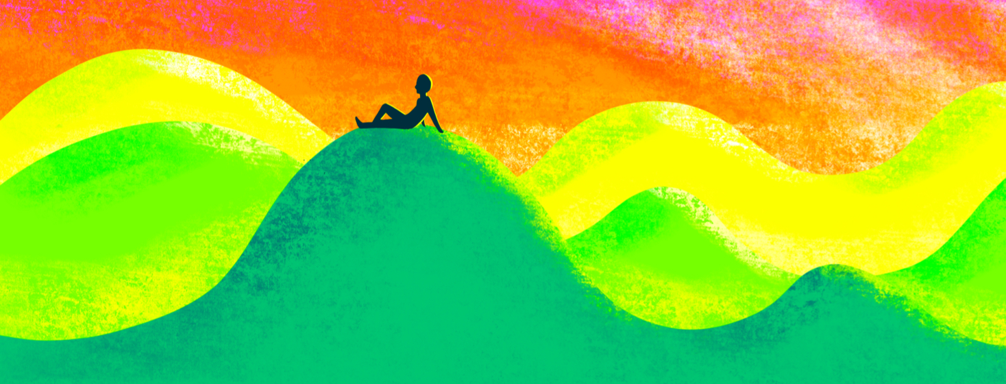 An adult takes a peaceful moment to sit on a series of 8 rolling hills.