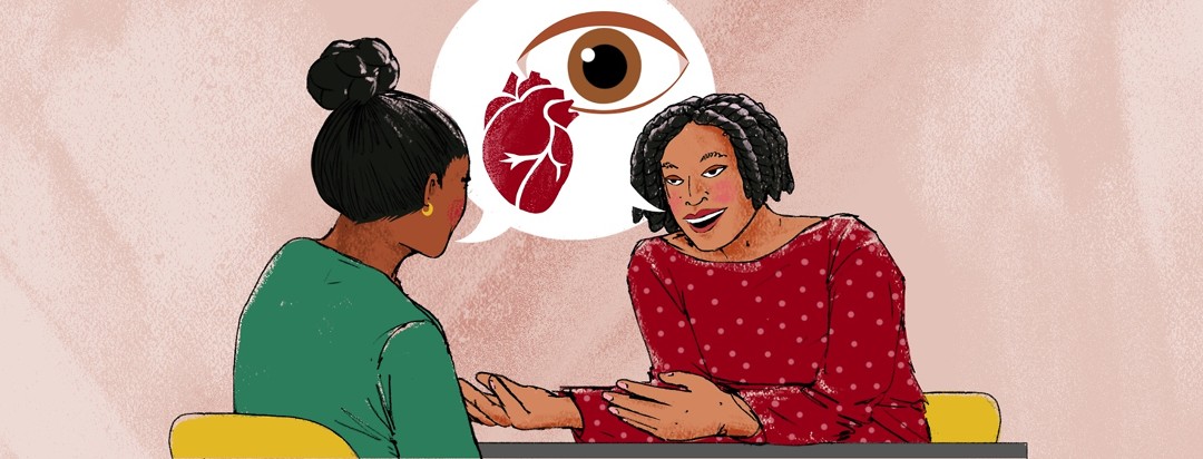 A woman is explaining the connection between the heart and the eyes to another woman.
