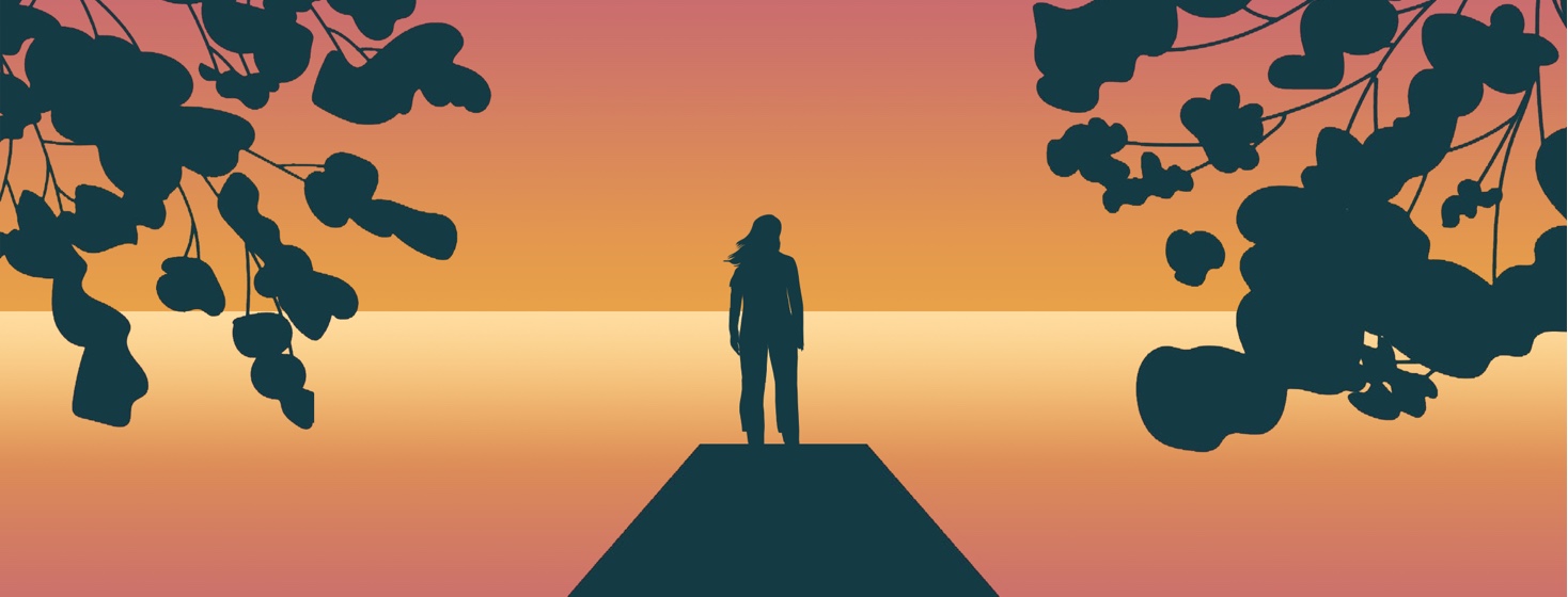 A person stands in silhouette at the end of a pier, facing the sunset on an ocean. Framing the image are silhouettes of flowering trees.