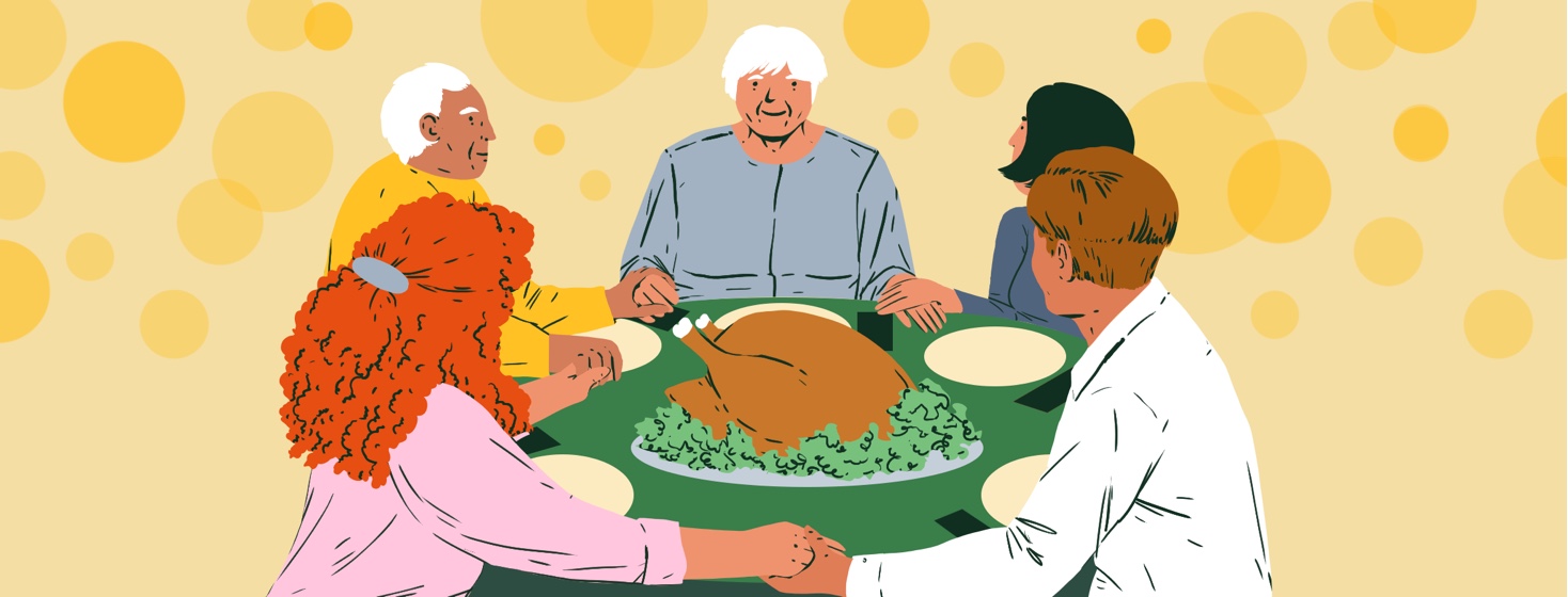 A family smiles and holds hands around a Thanksgiving turkey at a table set for dinner.