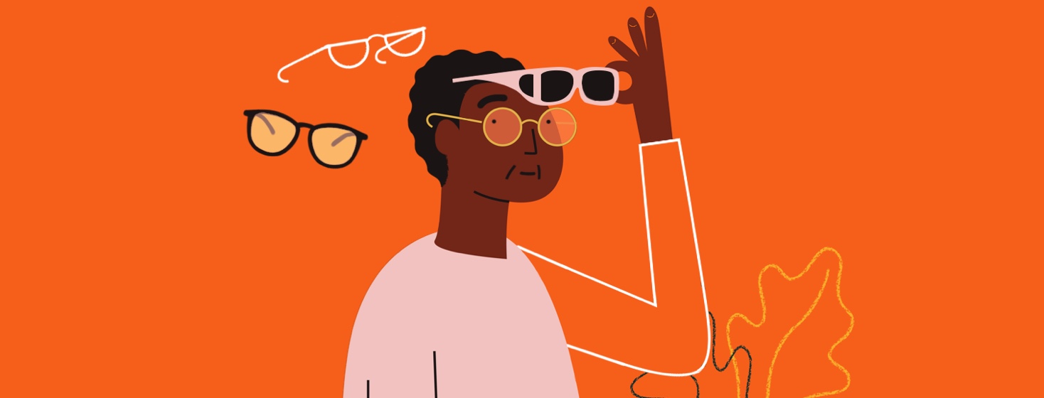 An older person holds sunglasses that fit over their regular glasses and looks over their shoulder at two other pairs of glasses.