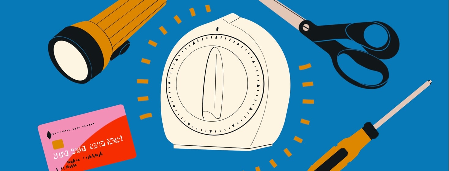 An egg timer is surround by other household items - scissors, a screwdriver, a credit card, and a flashlight.