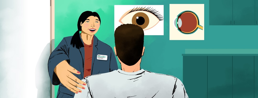 A woman with a name tag welcomes a man into an office that has anatomical eye posters on the walls.