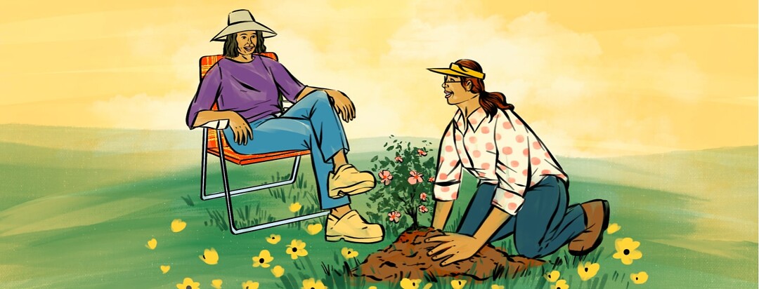 alt=a woman kneels on the ground, planting flowers. She smiles up at another woman smiling and sitting in a lawn chair.
