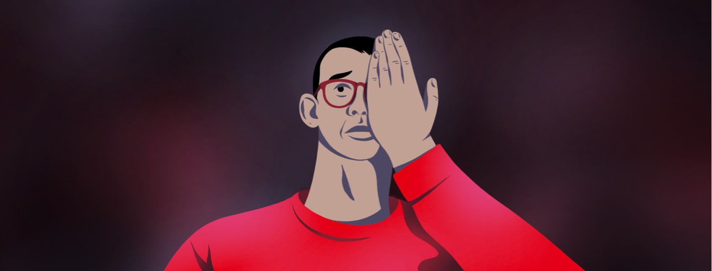 alt=a worried man wearing glasses covers one eye with his hand