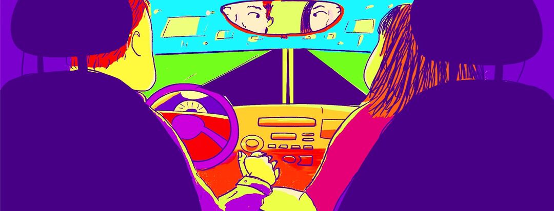 A couple is driving in a car and holding hands; the view in the rearview mirror shows them looking at each other.