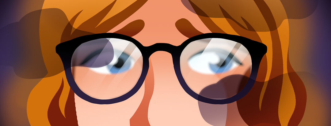 A stressed looking person with glasses on. The lenses look blurry.